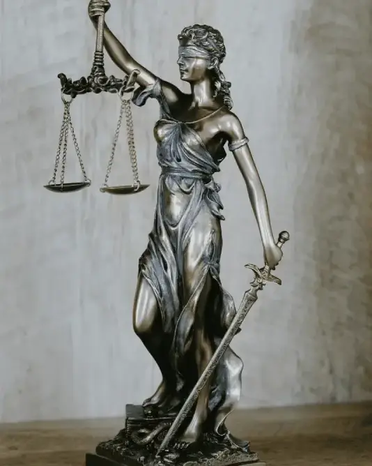 Bronze statuette of Lady Justice holding a set of scales and a sword